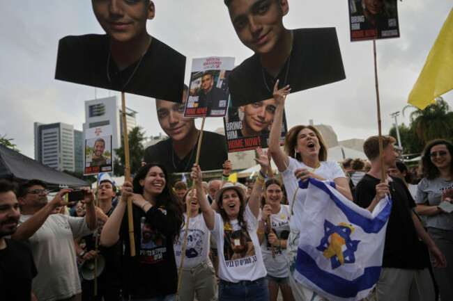 people-watch-a-live-broadcast-of-israeli-american-soldier-edan-alexander-as-he-is-released-from-hamas-captivity-in-gaza-at-a-plaza-known-as-the-hostages-square-in-tel-aviv-monday-may-12-2025-alex