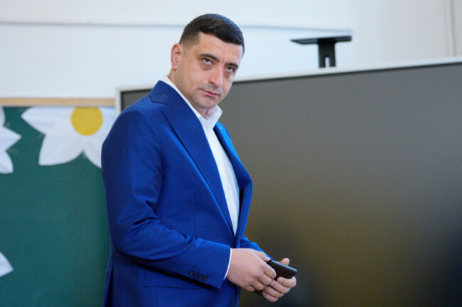 presidential-candidate-george-simion-before-casting-his-vote-in-the-second-round-of-the-countrys-presidential-election-redo-in-mogosoaia-romania-sunday-may-18-2025-ap-photoandreea-alexandru