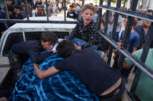 palestinians-children-mourn-over-the-body-of-their-father-mohammed-ghaben-who-was-killed-while-heading-to-an-aid-distribution-hub-during-his-funeral-in-gaza-city-wednesday-june-18-2025-ap-phot